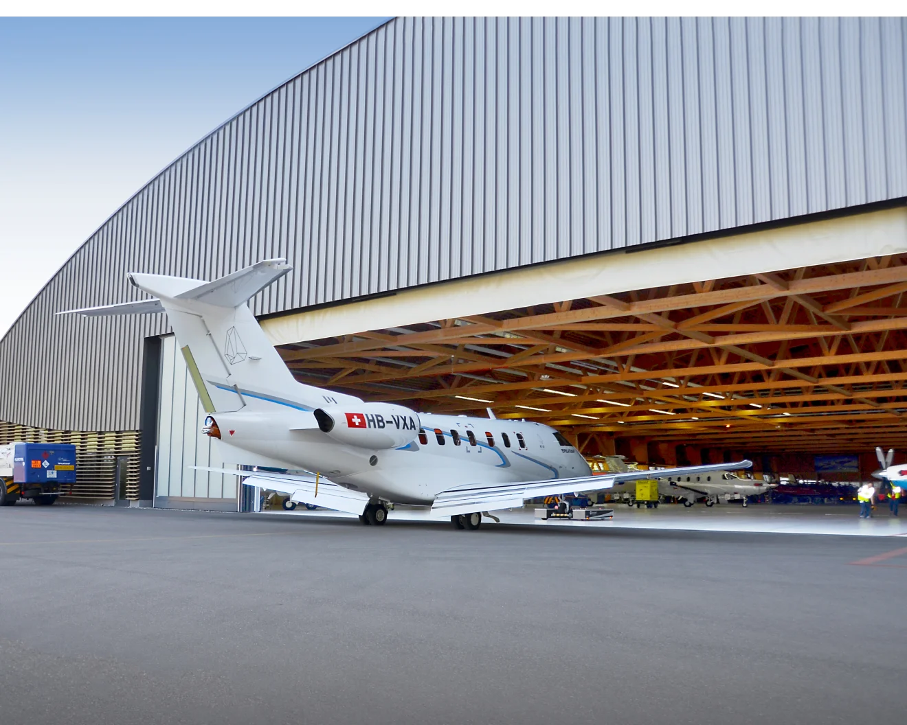 white airplane near the hangar